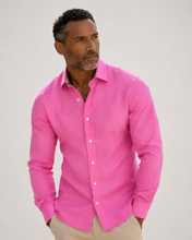 Load image into Gallery viewer, Man wearing a bright pink shirt against a plain background