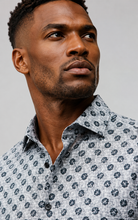 Load image into Gallery viewer, Man wearing a patterned shirt against a plain background