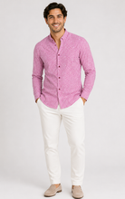 Load image into Gallery viewer, A man modeling a pink long-sleeve button-down shirt with white trousers and beige loafers, standing against a light gray studio background.